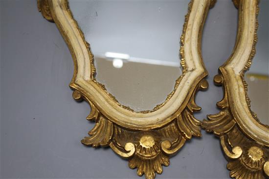 A pair of Italian giltwood cartouche shaped wall mirrors, width 25cm, height 43cm